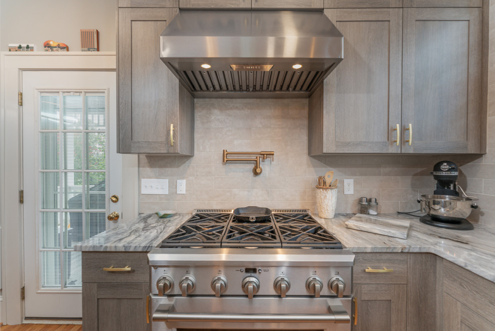 Kitchen - small transitional u-shaped kitchen idea in DC Metro with an undermount sink, shaker cabinets, marble countertops, stainless steel appliances and an island