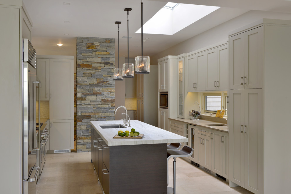 Design ideas for a large transitional u-shaped eat-in kitchen in New York with an undermount sink, flat-panel cabinets, beige cabinets, stainless steel appliances, with island, granite benchtops and limestone floors.