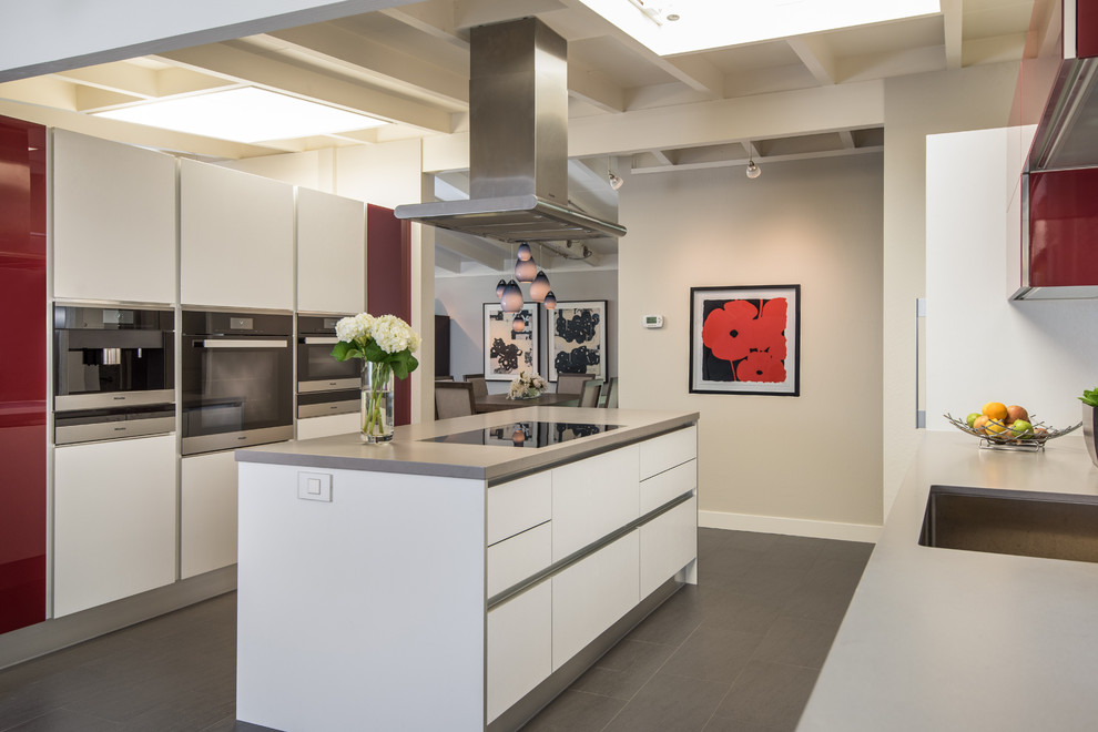 Design ideas for a mid-sized contemporary u-shaped eat-in kitchen in San Francisco with an undermount sink, flat-panel cabinets, white cabinets, with island, grey floor, grey benchtop, quartz benchtops, multi-coloured splashback and ceramic splashback.