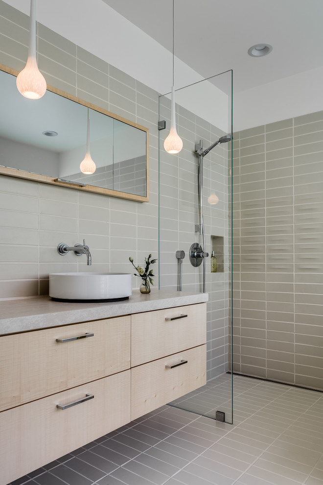 Design ideas for a mid-sized modern 3/4 bathroom in San Francisco with a vessel sink, flat-panel cabinets, light wood cabinets, limestone benchtops, a curbless shower, a one-piece toilet, ceramic tile, white walls, ceramic floors, a japanese tub and beige tile.