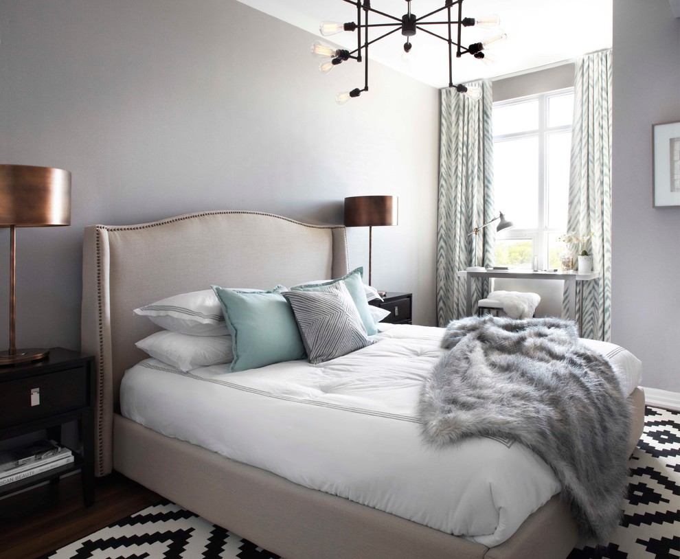 This is an example of a transitional bedroom in Calgary with grey walls and dark hardwood floors.