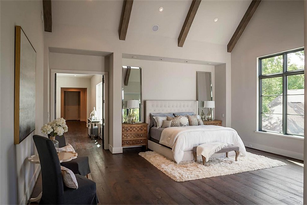 Large traditional master bedroom in Houston with white walls, dark hardwood floors, no fireplace and brown floor.
