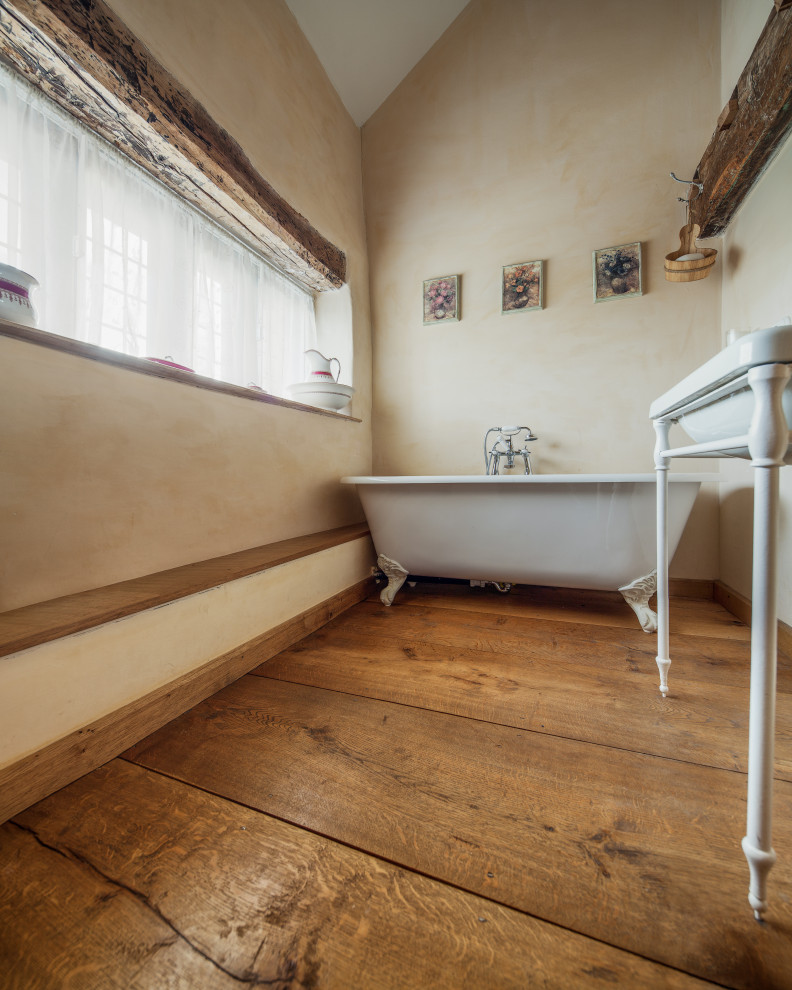 Esempio di una stanza da bagno country con pavimento in legno massello medio