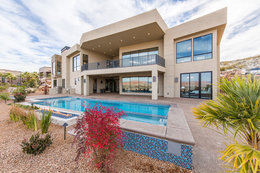 Example of a large transitional backyard concrete paver and custom-shaped natural pool fountain design in Las Vegas