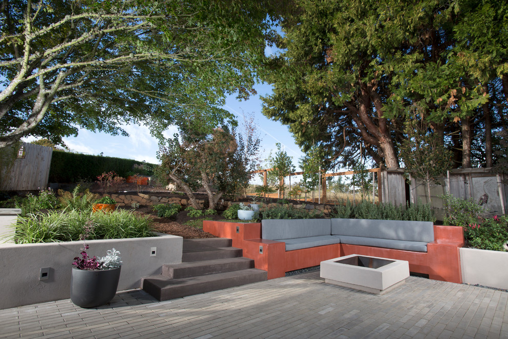 Inspiration for an expansive midcentury backyard patio in Portland with a fire feature, concrete pavers and no cover.