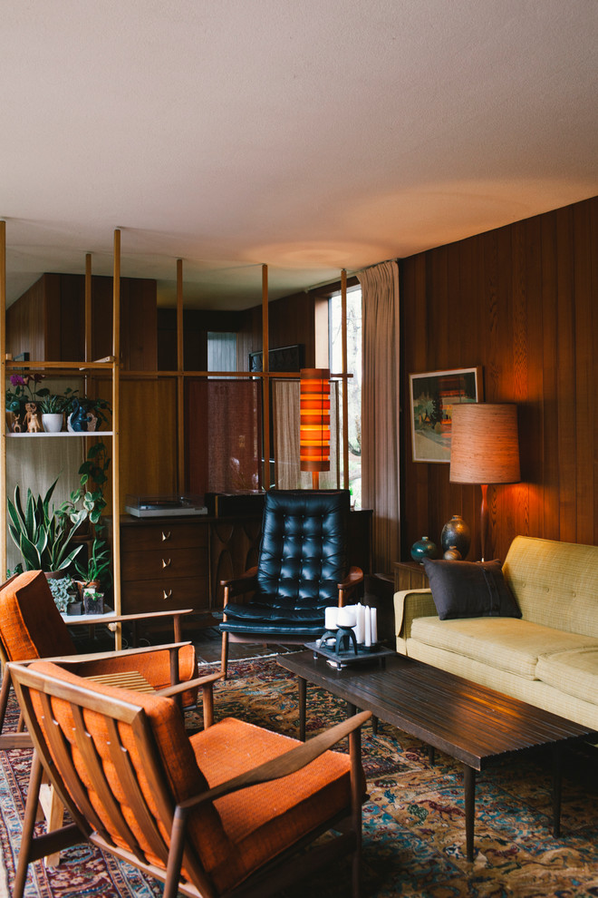 This is an example of a mid-sized midcentury formal enclosed living room in Seattle with brown walls, a standard fireplace, a brick fireplace surround and no tv.