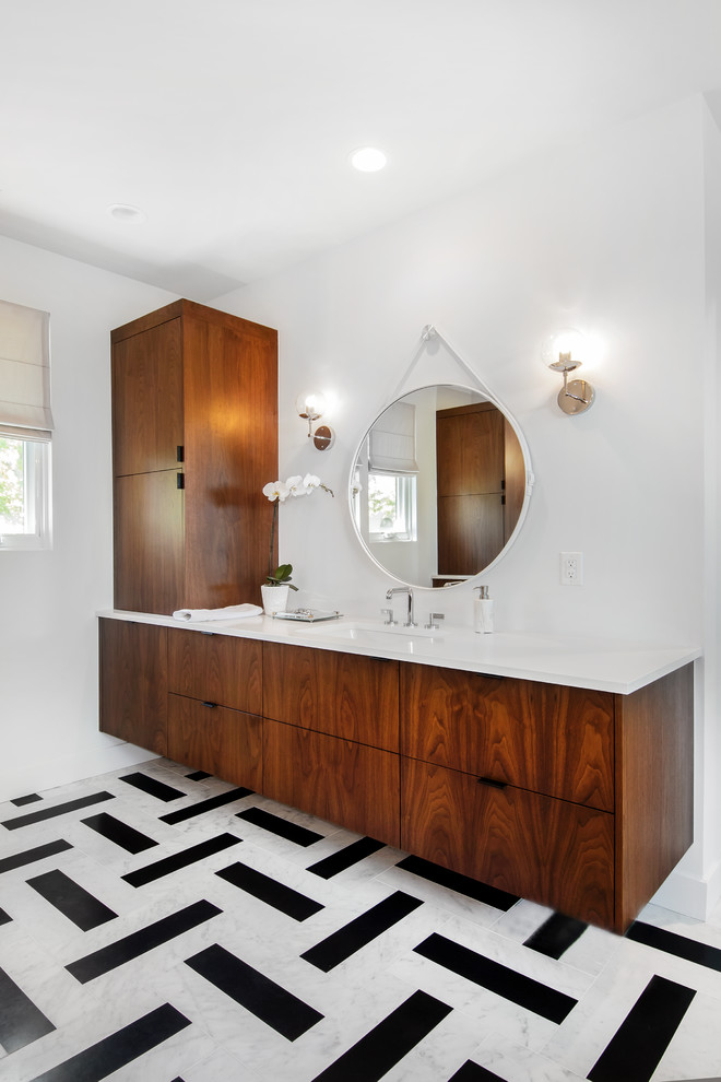 Inspiration for a midcentury bathroom in Denver with flat-panel cabinets, dark wood cabinets, white walls, an undermount sink, multi-coloured floor and white benchtops.