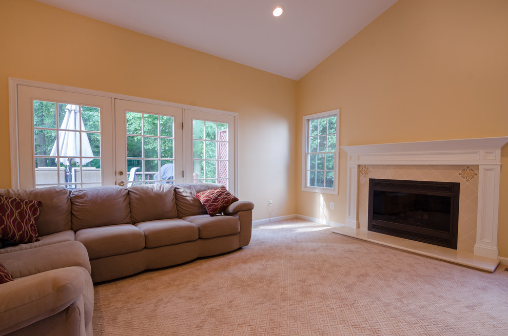 Inspiration for a large traditional open concept family room in DC Metro with yellow walls, carpet, a standard fireplace and a tile fireplace surround.