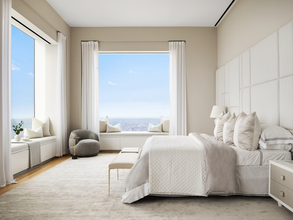 Design ideas for a contemporary master bedroom in New York with beige walls, light hardwood floors and no fireplace.