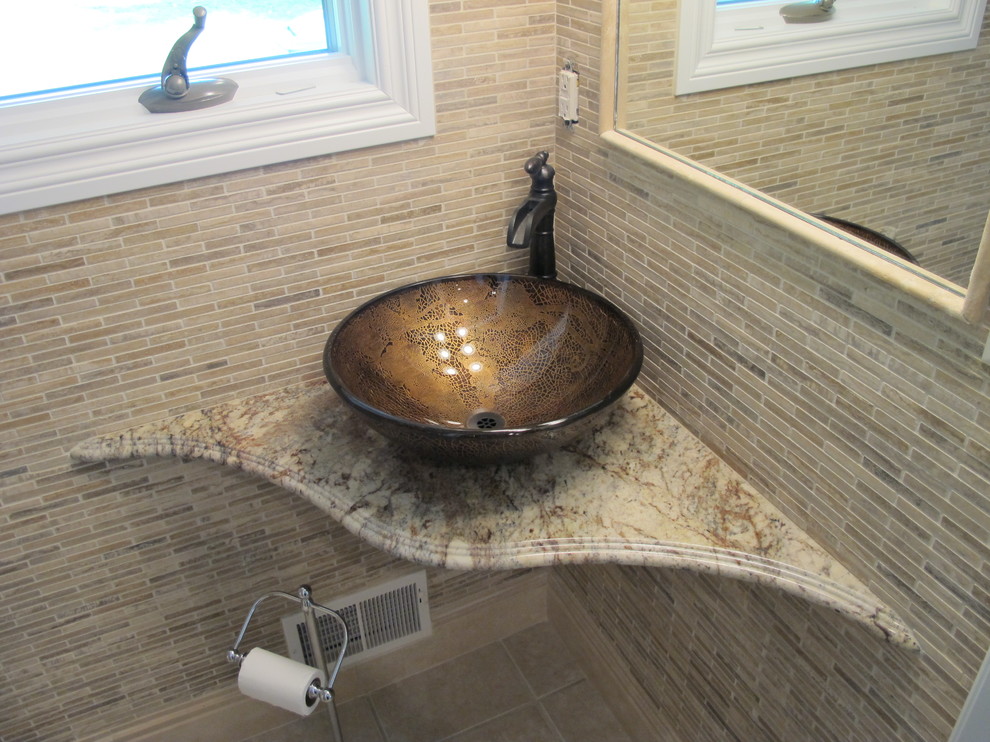 This is an example of a contemporary bathroom in Other with granite benchtops, a vessel sink, beige tile, stone tile and travertine floors.