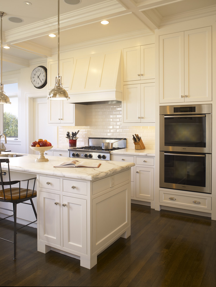 Inspiration for a traditional kitchen in San Francisco with beaded inset cabinets, white cabinets, marble benchtops, white splashback, subway tile splashback and stainless steel appliances.