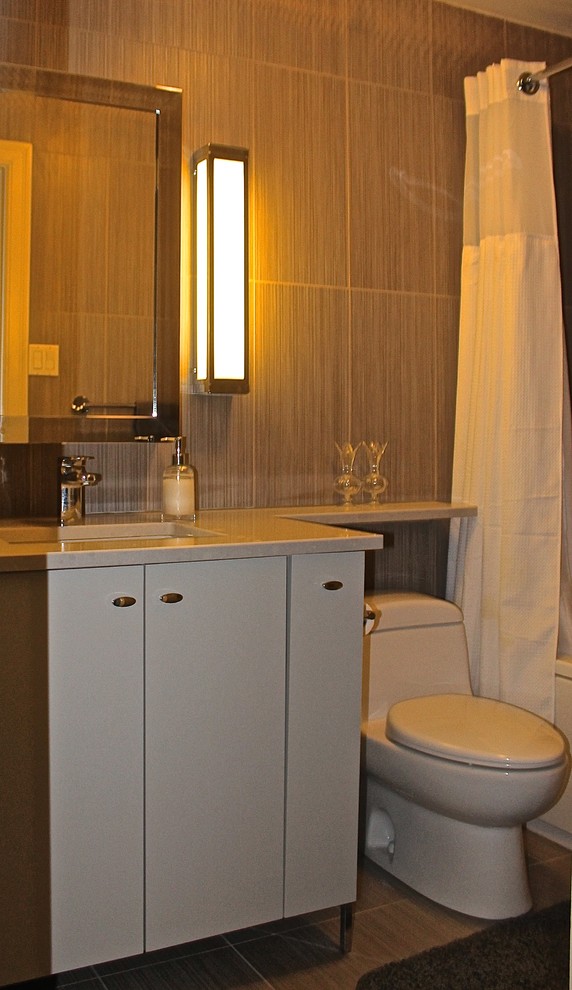 Design ideas for a small contemporary bathroom in Ottawa with an undermount sink, flat-panel cabinets, white cabinets, quartzite benchtops, an alcove tub, a shower/bathtub combo, a one-piece toilet, gray tile, porcelain tile, grey walls and porcelain floors.