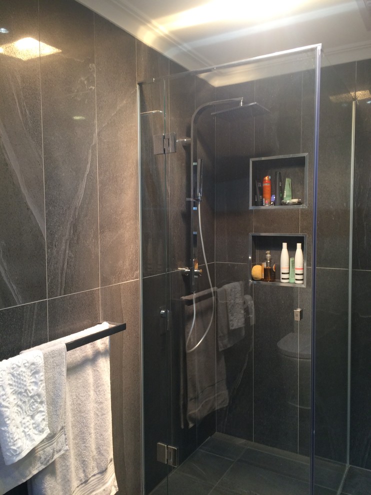 Photo of a small modern master bathroom in Melbourne with white cabinets, a corner shower, a two-piece toilet, porcelain tile, porcelain floors, a vessel sink and engineered quartz benchtops.