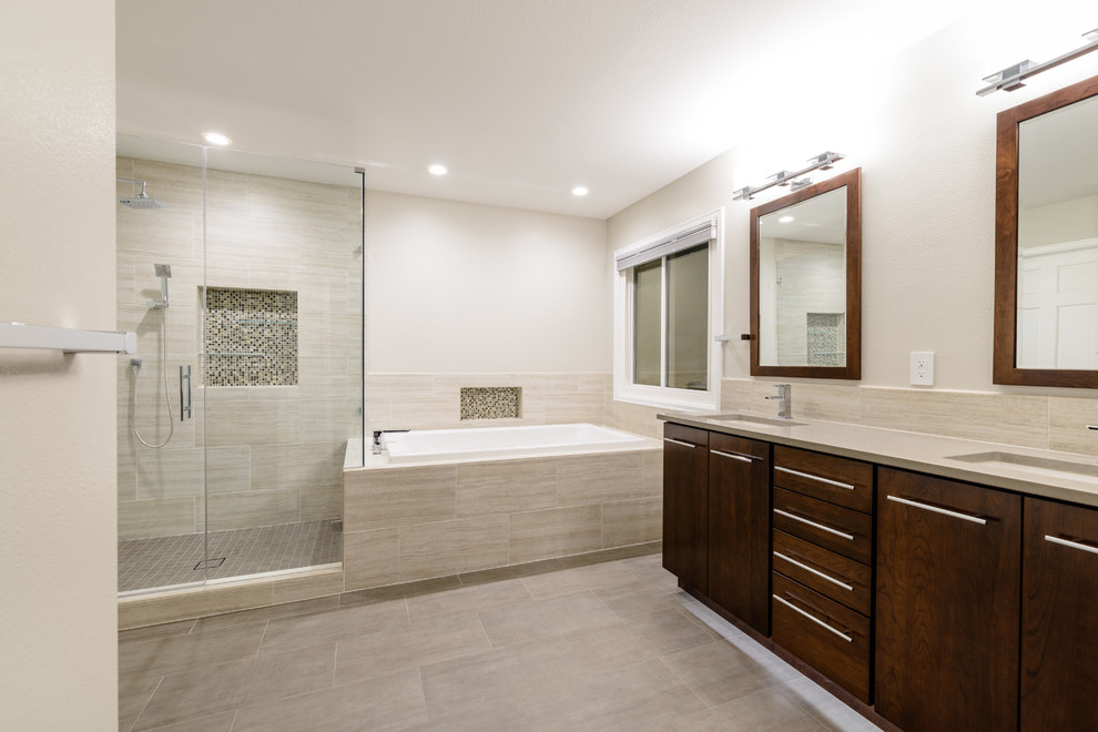 This is an example of a large contemporary master bathroom in Denver with flat-panel cabinets, dark wood cabinets, a corner tub, a corner shower, beige tile, porcelain tile, beige walls, vinyl floors, an undermount sink, tile benchtops, beige floor and a hinged shower door.