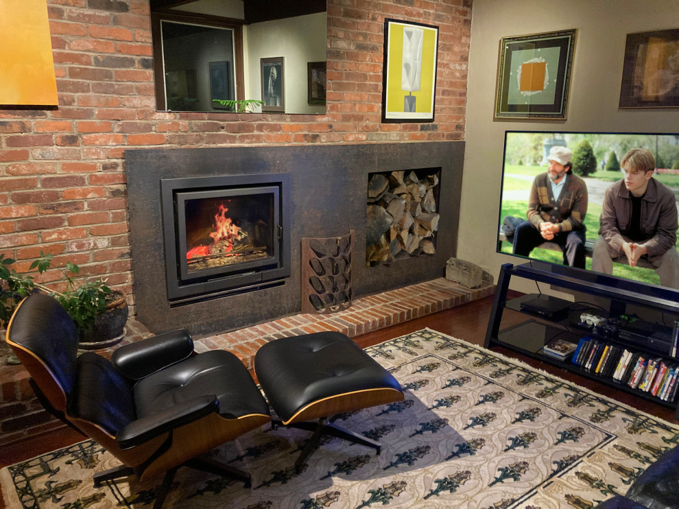 This is an example of a large industrial living room in Other with a wood stove and a metal fireplace surround.