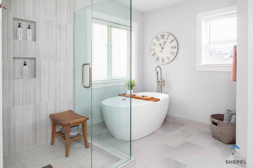 This is an example of a large transitional master bathroom in Seattle with flat-panel cabinets, white cabinets, a freestanding tub, a corner shower, a one-piece toilet, white tile, porcelain tile, white walls, porcelain floors, an undermount sink, engineered quartz benchtops, white floor, a hinged shower door, white benchtops, a niche, a double vanity and a built-in vanity.