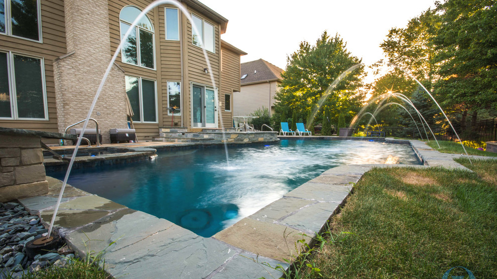 Inspiration for a mid-sized rustic backyard stone and custom-shaped lap pool remodel in Chicago