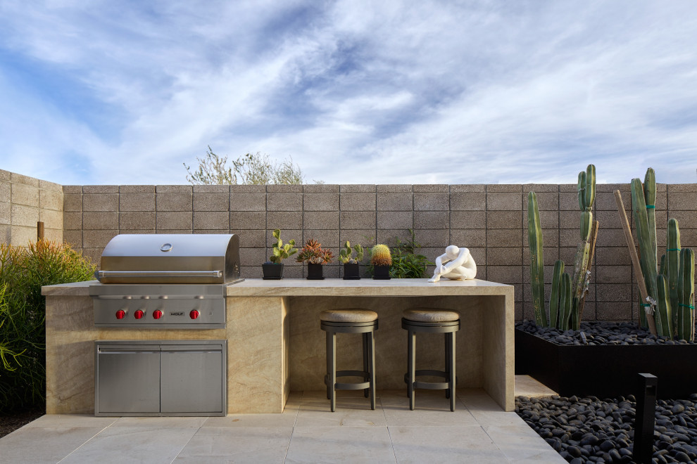 Inspiration for an expansive backyard patio in Phoenix with tile and a roof extension.