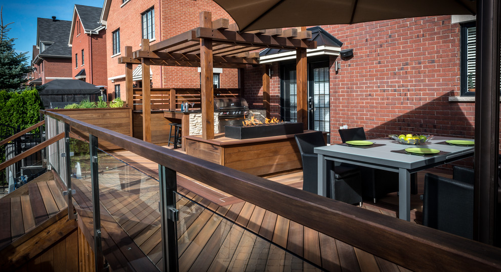This is an example of a contemporary backyard patio in Montreal with decking.