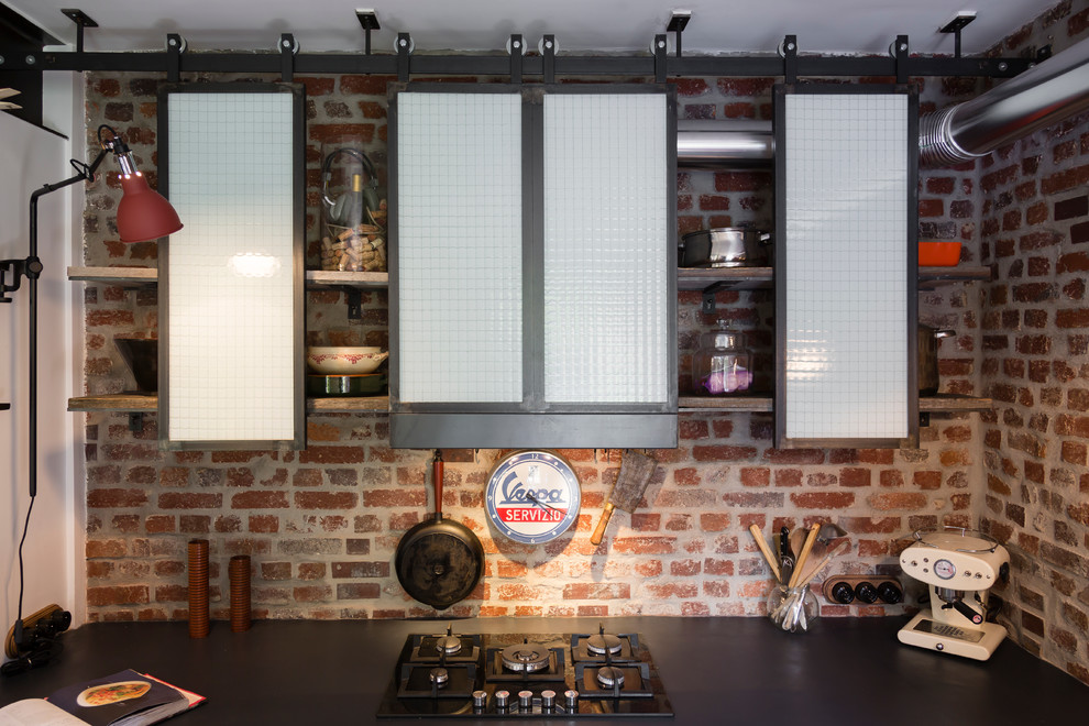 This is an example of a mid-sized industrial single-wall separate kitchen in Paris with no island.