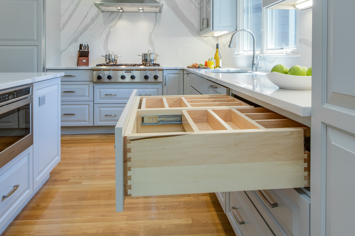 Inspiration for a large transitional l-shaped medium tone wood floor open concept kitchen remodel in Boston with an undermount sink, raised-panel cabinets, gray cabinets, quartz countertops, stone slab backsplash, paneled appliances and an island