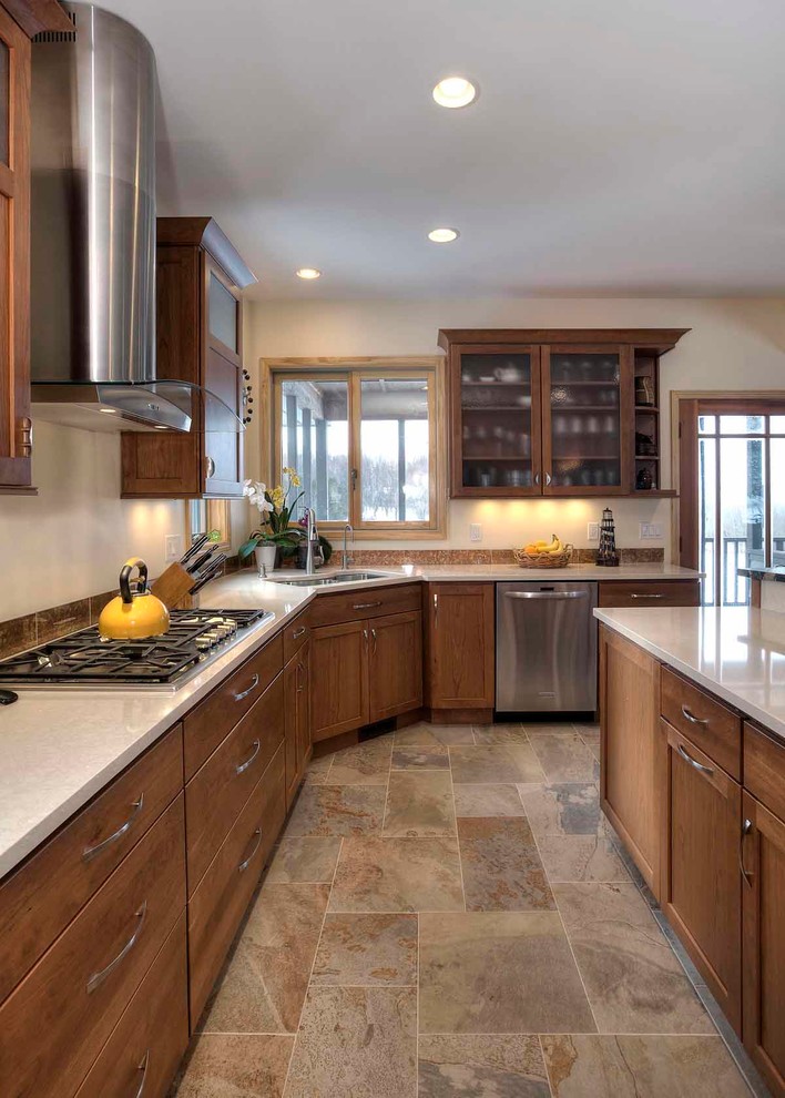 Mid-sized transitional u-shaped slate floor eat-in kitchen photo with an undermount sink, flat-panel cabinets, medium tone wood cabinets, quartz countertops, brown backsplash, stone tile backsplash, stainless steel appliances and an island