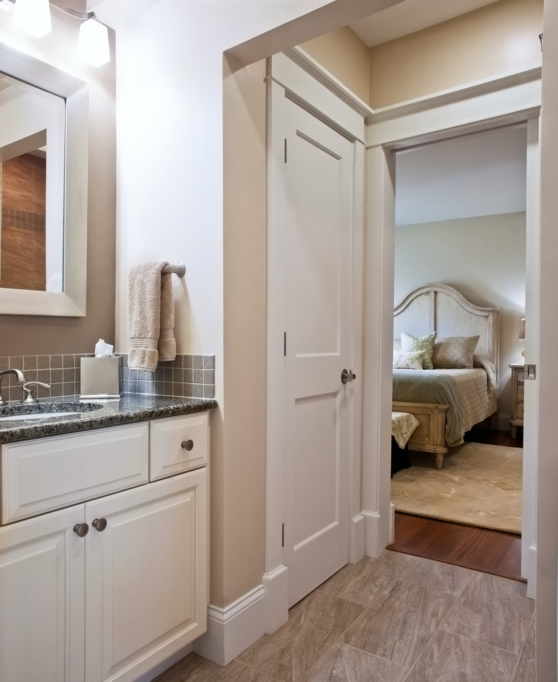Inspiration for a mid-sized transitional 3/4 gray tile and ceramic tile porcelain tile bathroom remodel with raised-panel cabinets, white cabinets, beige walls, an undermount sink and granite countertops