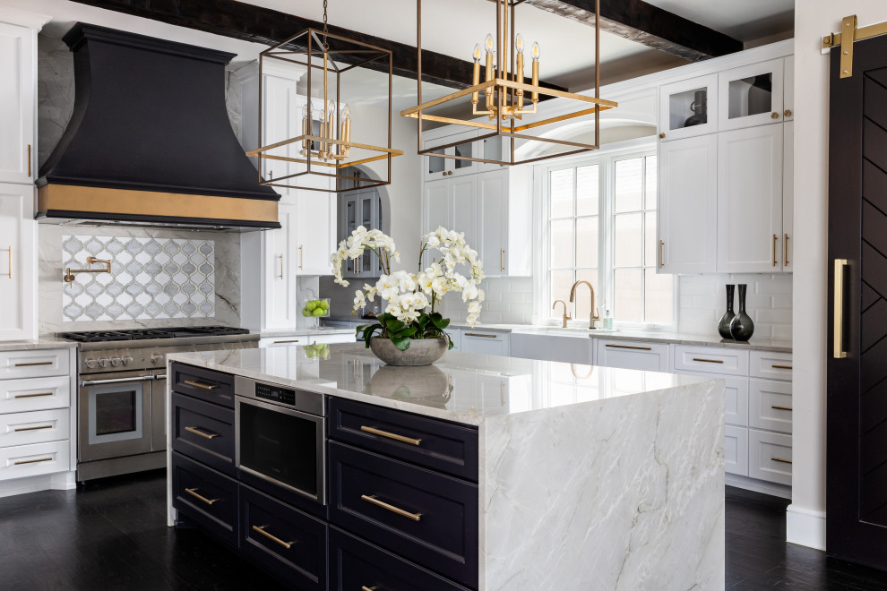 Inspiration for a large classic open plan kitchen in Dallas with a belfast sink, recessed-panel cabinets, black cabinets, quartz worktops, metallic splashback, stainless steel appliances, dark hardwood flooring, an island, black floors and exposed beams.