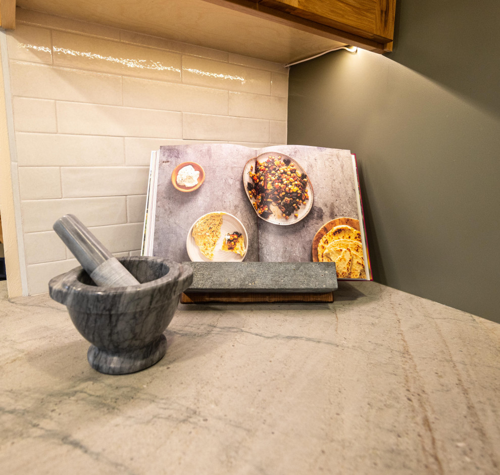 Eat-in kitchen - large rustic u-shaped light wood floor and brown floor eat-in kitchen idea with a farmhouse sink, shaker cabinets, quartzite countertops, gray backsplash, ceramic backsplash, stainless steel appliances, a peninsula and gray countertops