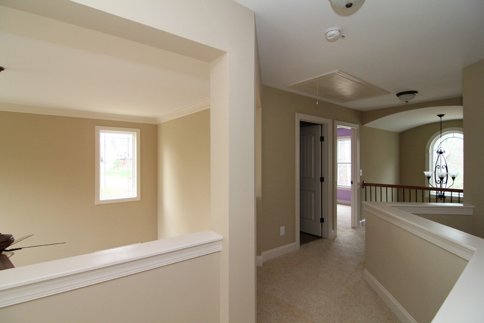 Design ideas for a large traditional hallway in Raleigh with beige walls and carpet.