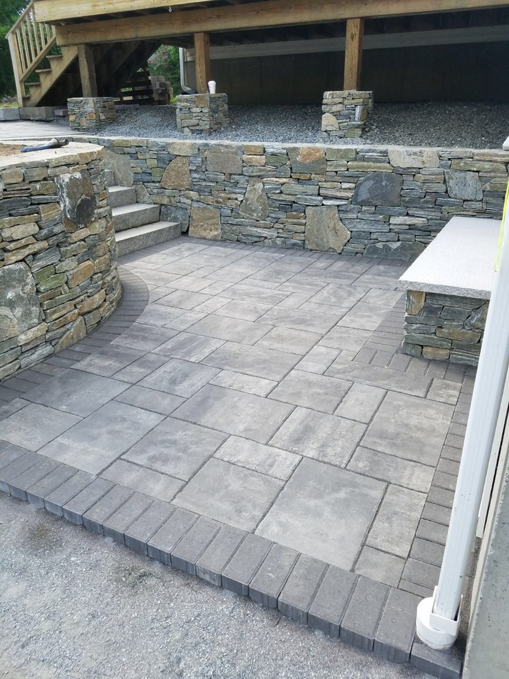 Design ideas for a mid-sized traditional backyard patio in Boston with natural stone pavers and no cover.