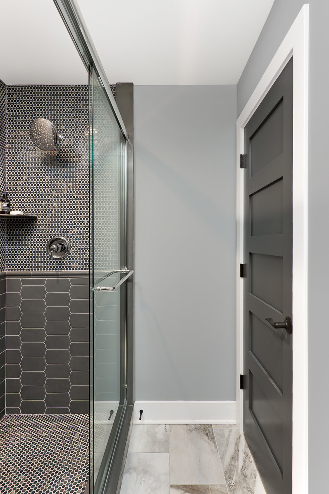 This is an example of a transitional bathroom in Chicago with a corner shower, brown tile, gray tile, mosaic tile, grey walls, beige floor and a sliding shower screen.