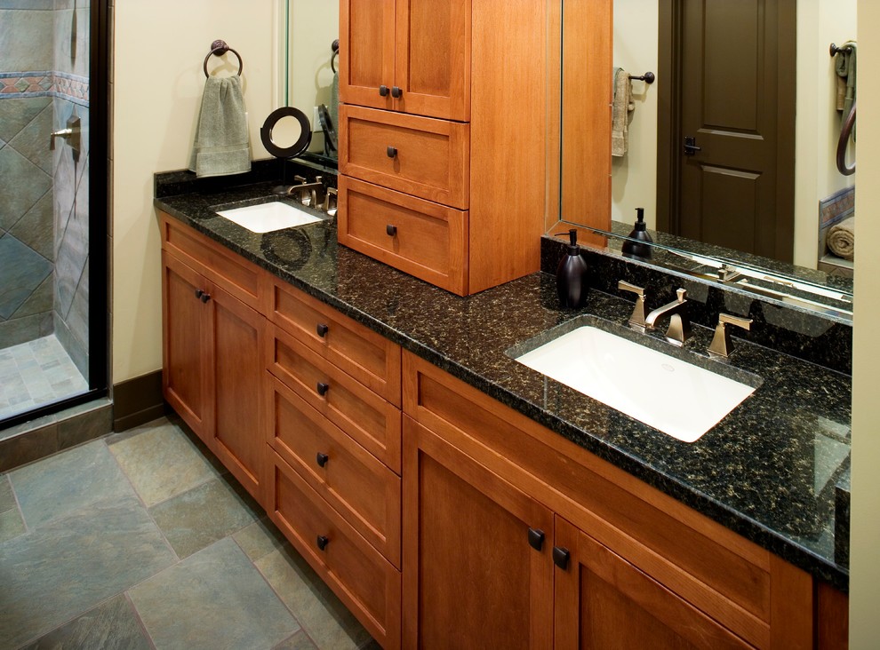 Inspiration for a large arts and crafts master bathroom in Other with shaker cabinets, medium wood cabinets, an alcove shower, black walls, slate floors, an undermount sink, granite benchtops, grey floor, a hinged shower door and black benchtops.