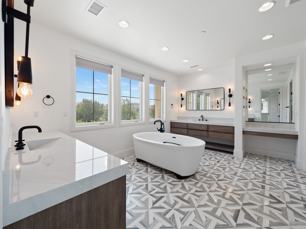 Mid-sized contemporary master bathroom in Orange County with dark wood cabinets, a freestanding tub, an alcove shower, a one-piece toilet, gray tile, marble, white walls, mosaic tile floors, an integrated sink, engineered quartz benchtops, multi-coloured floor, a hinged shower door, grey benchtops, a shower seat, a double vanity and a built-in vanity.