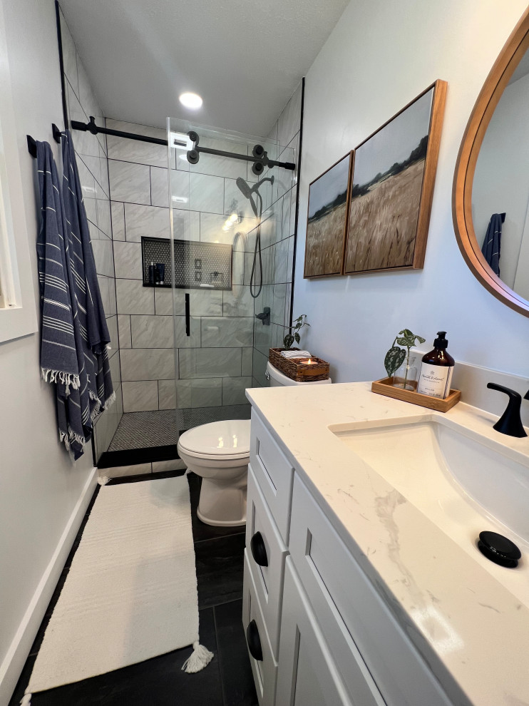 Small transitional master bathroom in Other with flat-panel cabinets, white cabinets, a two-piece toilet, white tile, porcelain tile, white walls, vinyl floors, an undermount sink, engineered quartz benchtops, black floor, a sliding shower screen, white benchtops, a niche, a single vanity and a freestanding vanity.