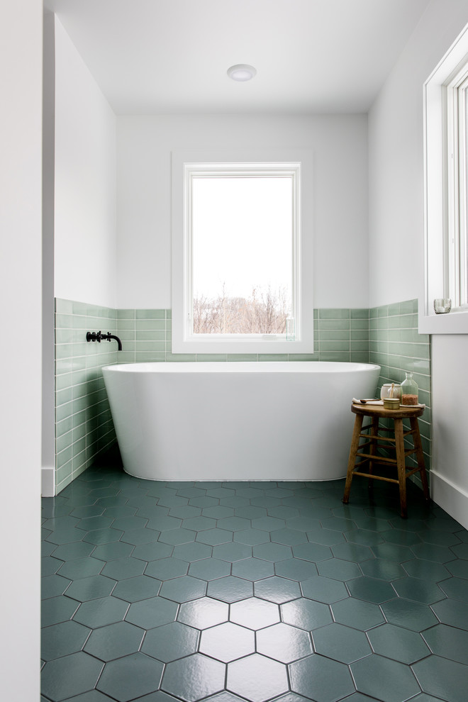 Large scandinavian master bathroom in Grand Rapids with flat-panel cabinets, white cabinets, a freestanding tub, an alcove shower, green tile, ceramic tile, white walls, ceramic floors, an undermount sink, quartzite benchtops, green floor, a hinged shower door and white benchtops.