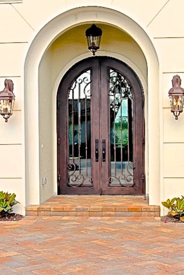 Large mediterranean front door in Miami with a double front door and a metal front door.