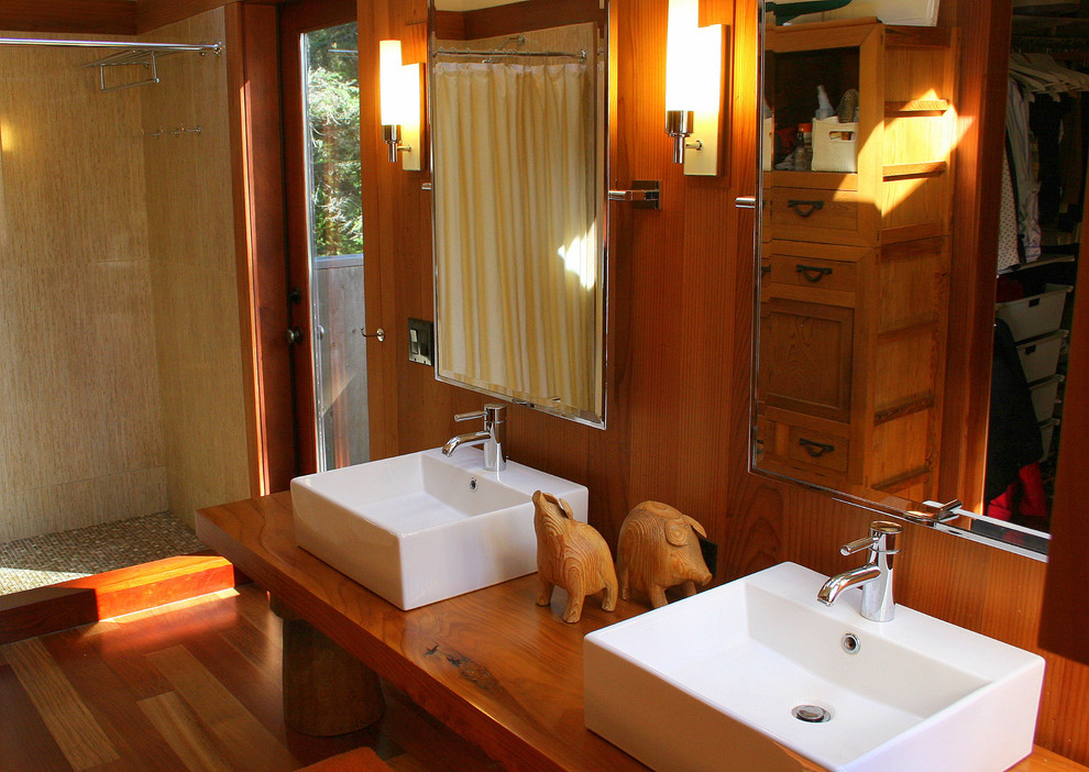 Design ideas for a mid-sized transitional master bathroom in San Francisco with a vessel sink, open cabinets, medium wood cabinets, wood benchtops, a double shower, multi-coloured tile, ceramic tile, orange walls and medium hardwood floors.