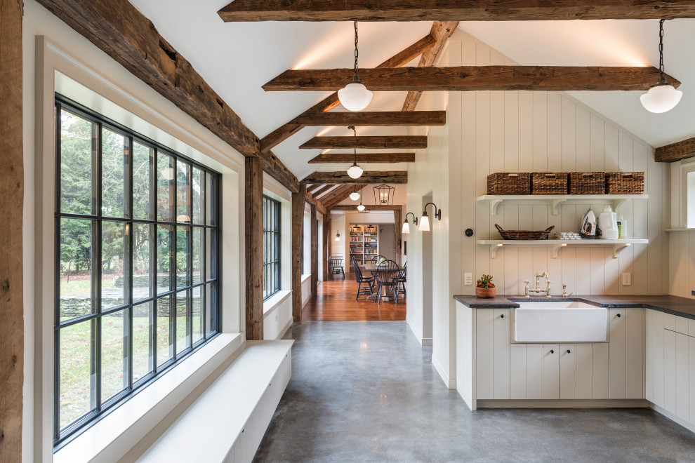 Inspiration for a huge farmhouse u-shaped medium tone wood floor and exposed beam open concept kitchen remodel in Boston with beaded inset cabinets, white cabinets, black backsplash, stainless steel appliances, an island and black countertops