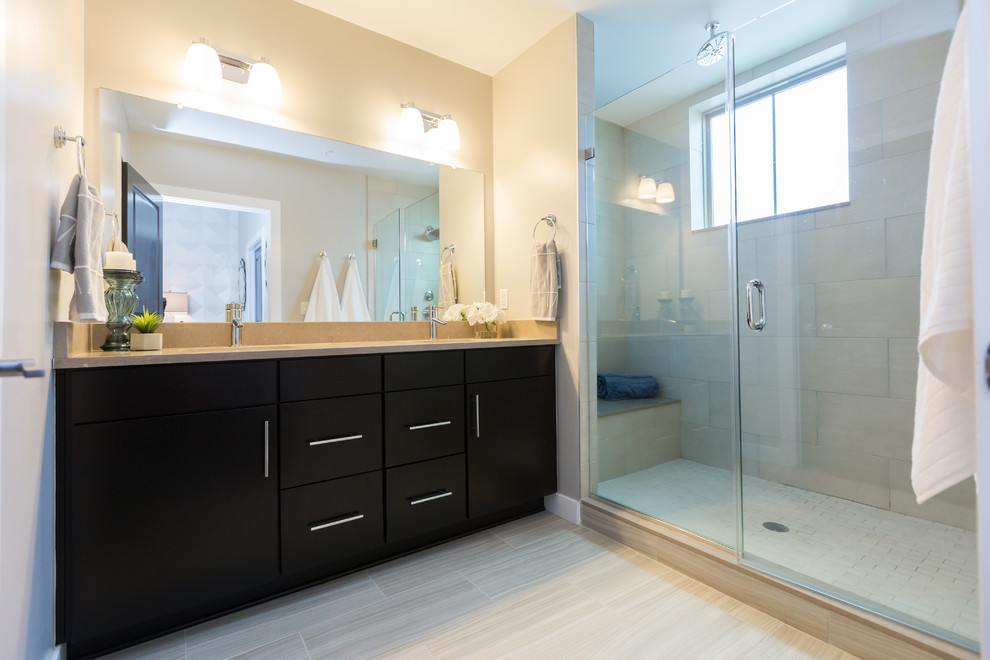 Inspiration for a large traditional master bathroom in Philadelphia with flat-panel cabinets, dark wood cabinets, an alcove shower, beige tile, ceramic tile, ceramic floors, an undermount sink, granite benchtops, beige floor, a hinged shower door, beige walls and beige benchtops.