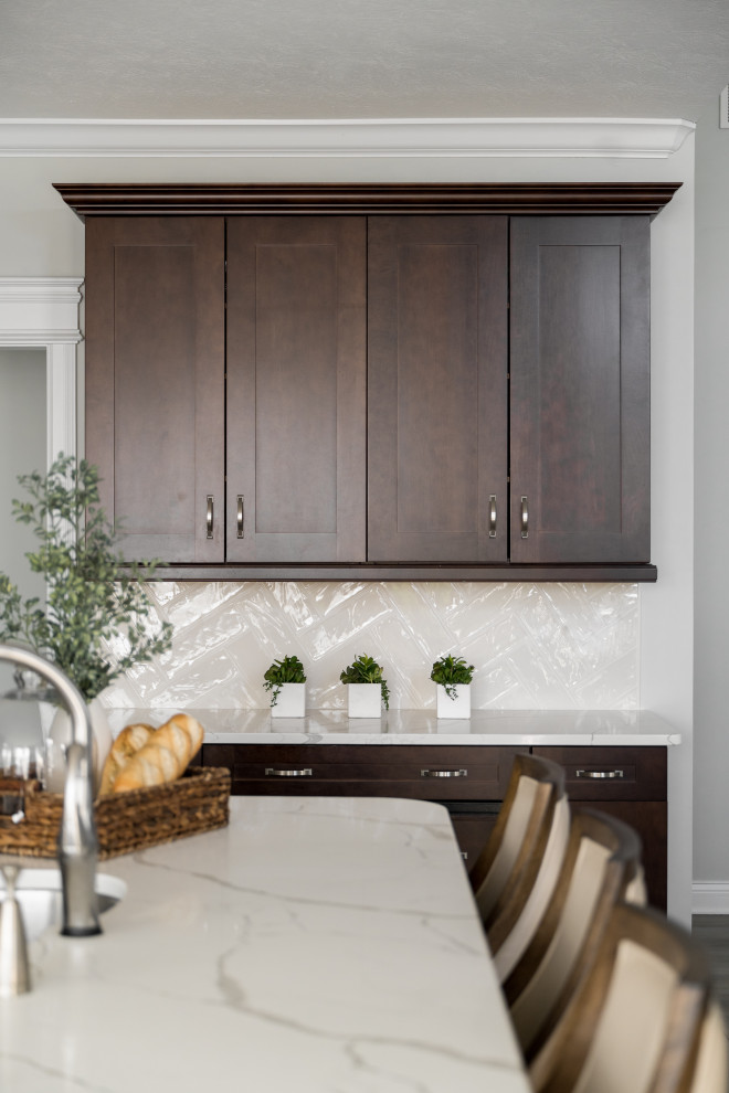 Design ideas for a mid-sized modern l-shaped separate kitchen in Indianapolis with an undermount sink, shaker cabinets, brown cabinets, marble benchtops, subway tile splashback, stainless steel appliances, with island and white benchtop.