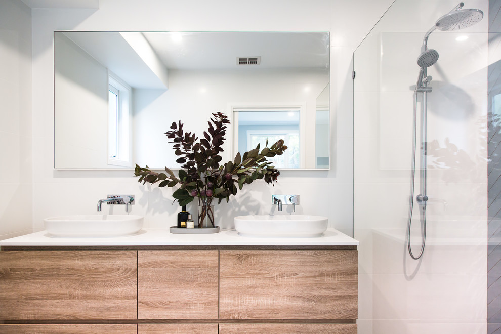 Photo of a large modern master bathroom in Melbourne with flat-panel cabinets, medium wood cabinets, an open shower, a one-piece toilet, white tile, ceramic tile, white walls, porcelain floors, a vessel sink, engineered quartz benchtops, grey floor, an open shower and white benchtops.