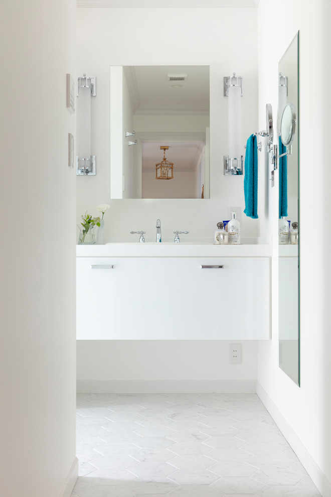 This is an example of a contemporary powder room in Tokyo with flat-panel cabinets, white cabinets, white walls, a drop-in sink and white floor.