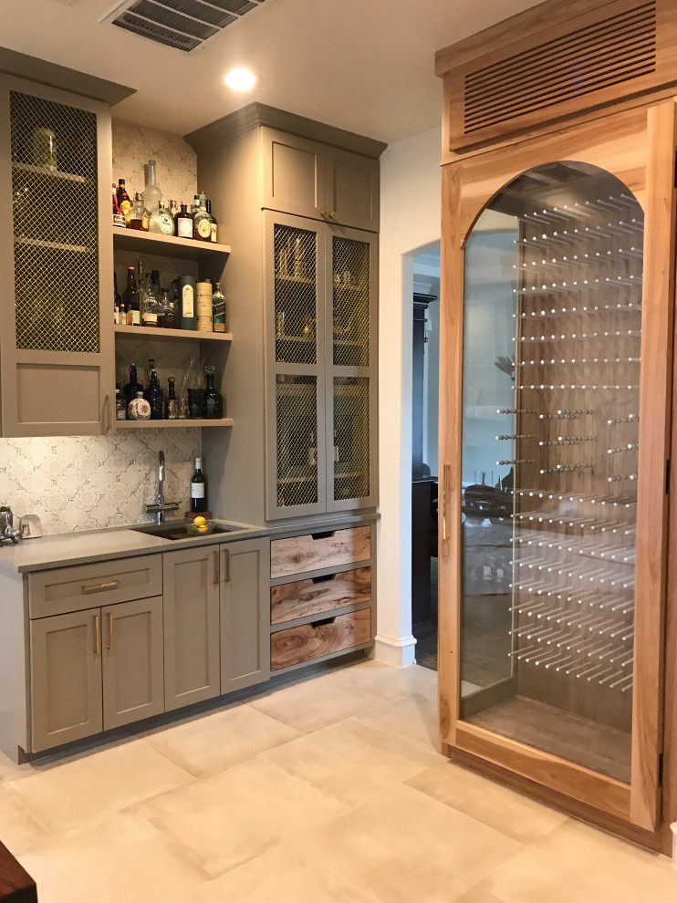 This is an example of a large beach style wine cellar in Tampa with travertine floors, display racks and beige floor.