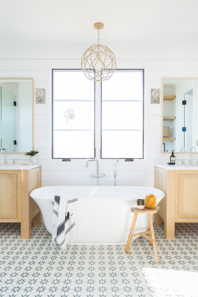 This is an example of a small country master bathroom in Orange County with shaker cabinets, light wood cabinets, a freestanding tub, white tile, an undermount sink, marble benchtops and white benchtops.