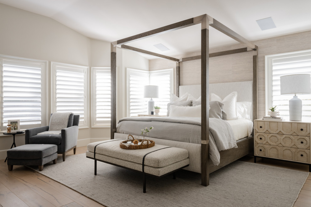 Diseño de dormitorio principal y abovedado tradicional renovado con paredes blancas, suelo de madera clara y suelo beige