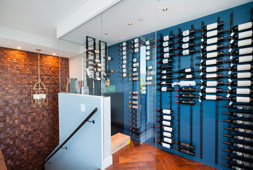 Inspiration for a small transitional wine cellar in Vancouver with medium hardwood floors and storage racks.