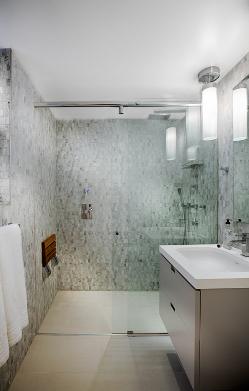 Mid-sized contemporary master bathroom in New York with furniture-like cabinets, dark wood cabinets, a curbless shower, a wall-mount toilet, black and white tile, cement tile, yellow walls, ceramic floors, a drop-in sink, marble benchtops, beige floor, a sliding shower screen and white benchtops.