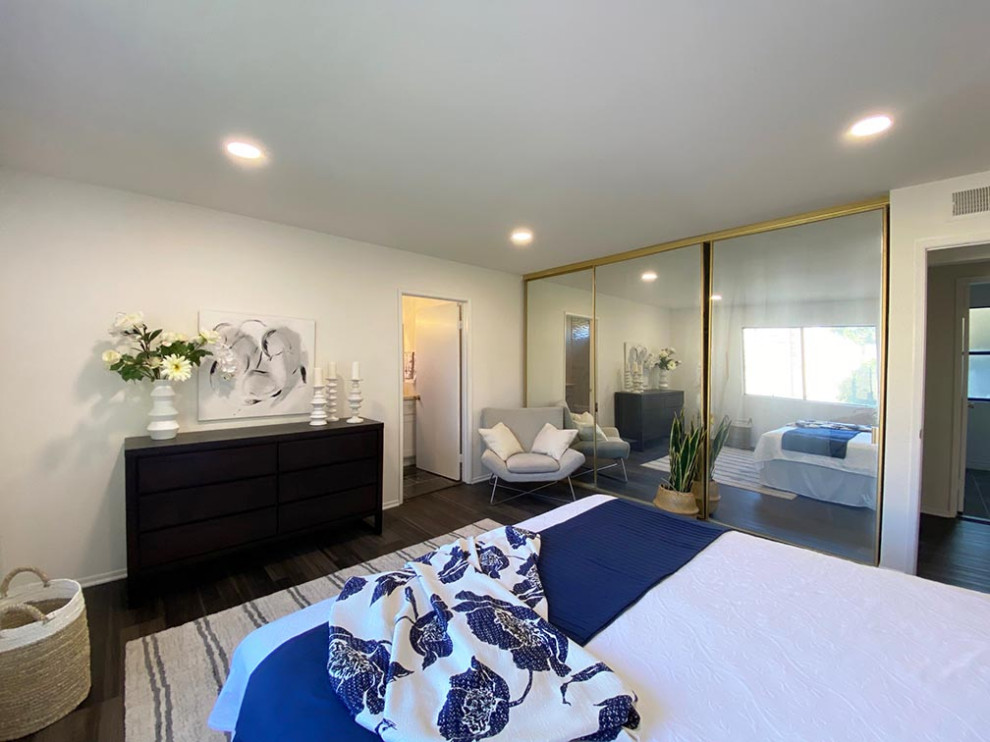 Medium sized traditional master bedroom in Los Angeles with white walls, vinyl flooring and grey floors.