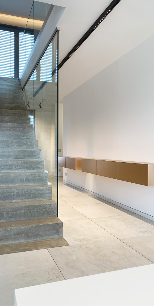 Geräumiger Moderner Flur mit grauer Wandfarbe, hellem Holzboden und beigem Boden in Sonstige